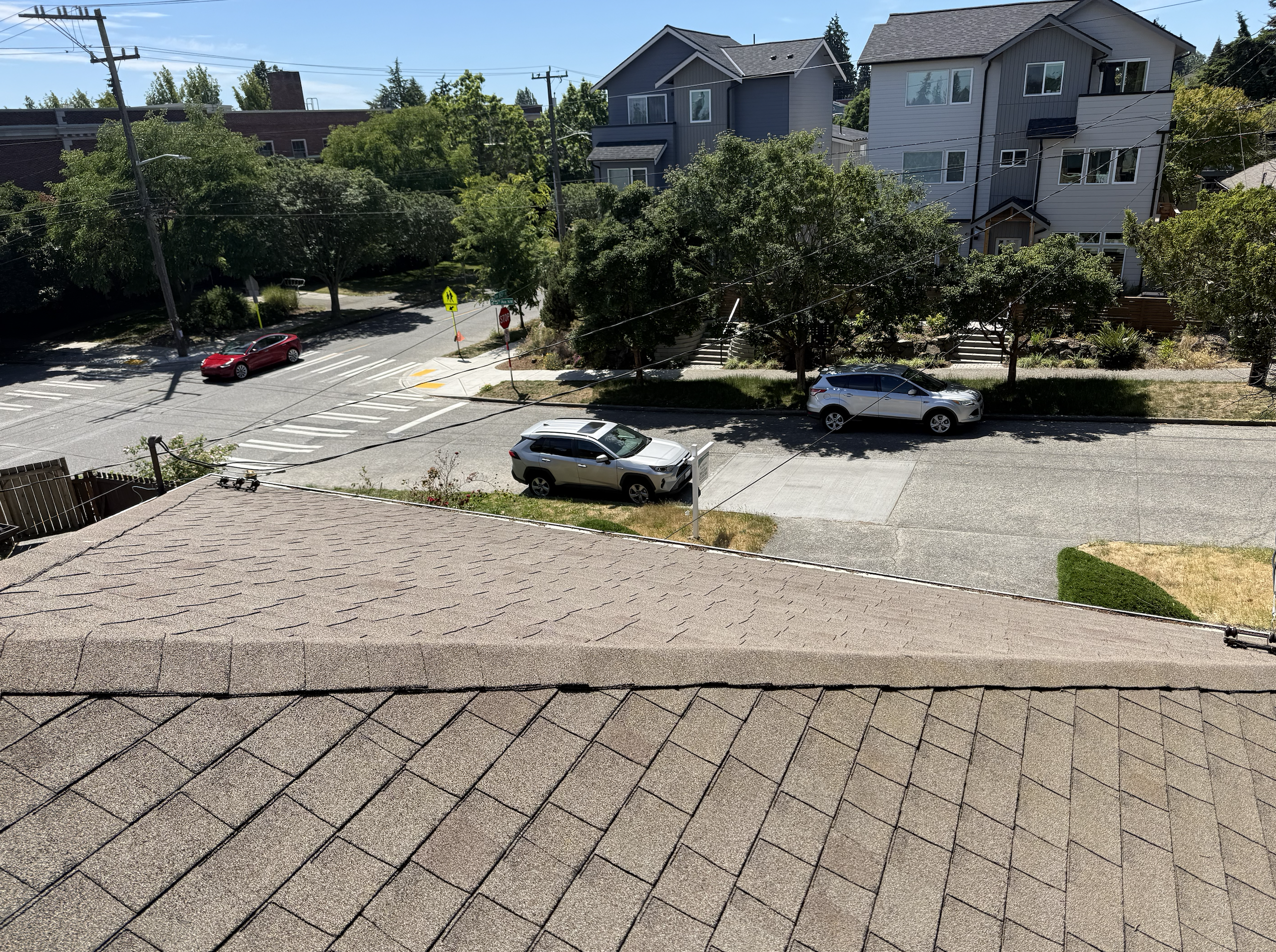 Roofing contractor inspecting an asphalt shingle roof in Redmond, WA — free roof inspection service for homeowners in Kirkland, Bellevue, and greater King County