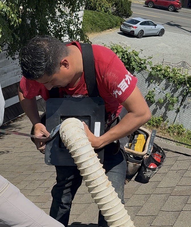 Real Great Roofing technician repairing a roof vent and fan vent on a residential home in Redmond, WA — roof ventilation repair serving Bellevue and Kirkland